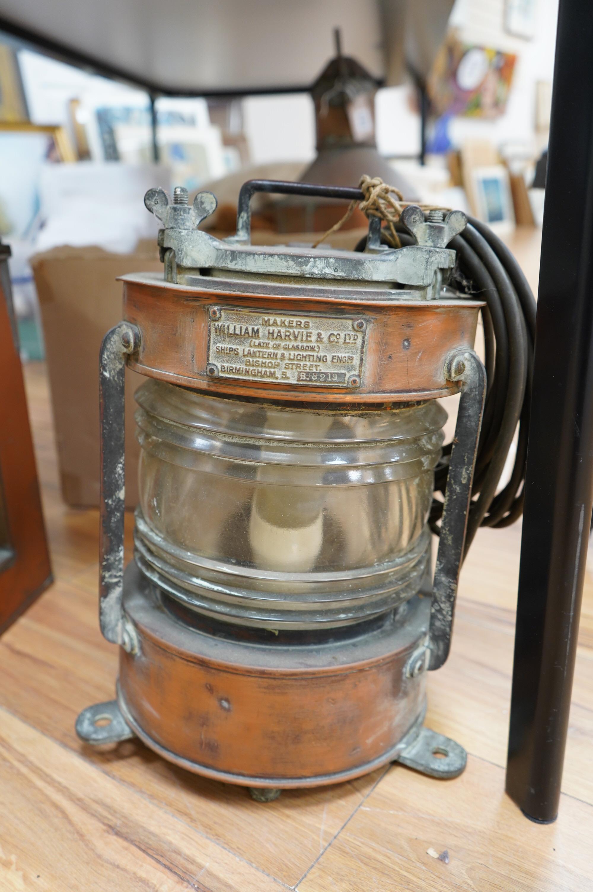 An early 20th century ship’s copper mast head lamp, and another copper ship’s lamp, largest 69cm high. Condition - fair